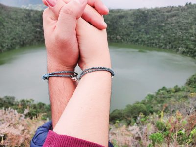 Matching Couple Bracelets holding hands at lake